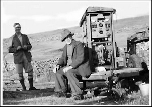 Photograph of Eddy Percy, Eli Simpson, and the generator in 1953